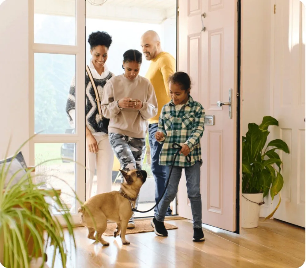 Family coming home with their dog
